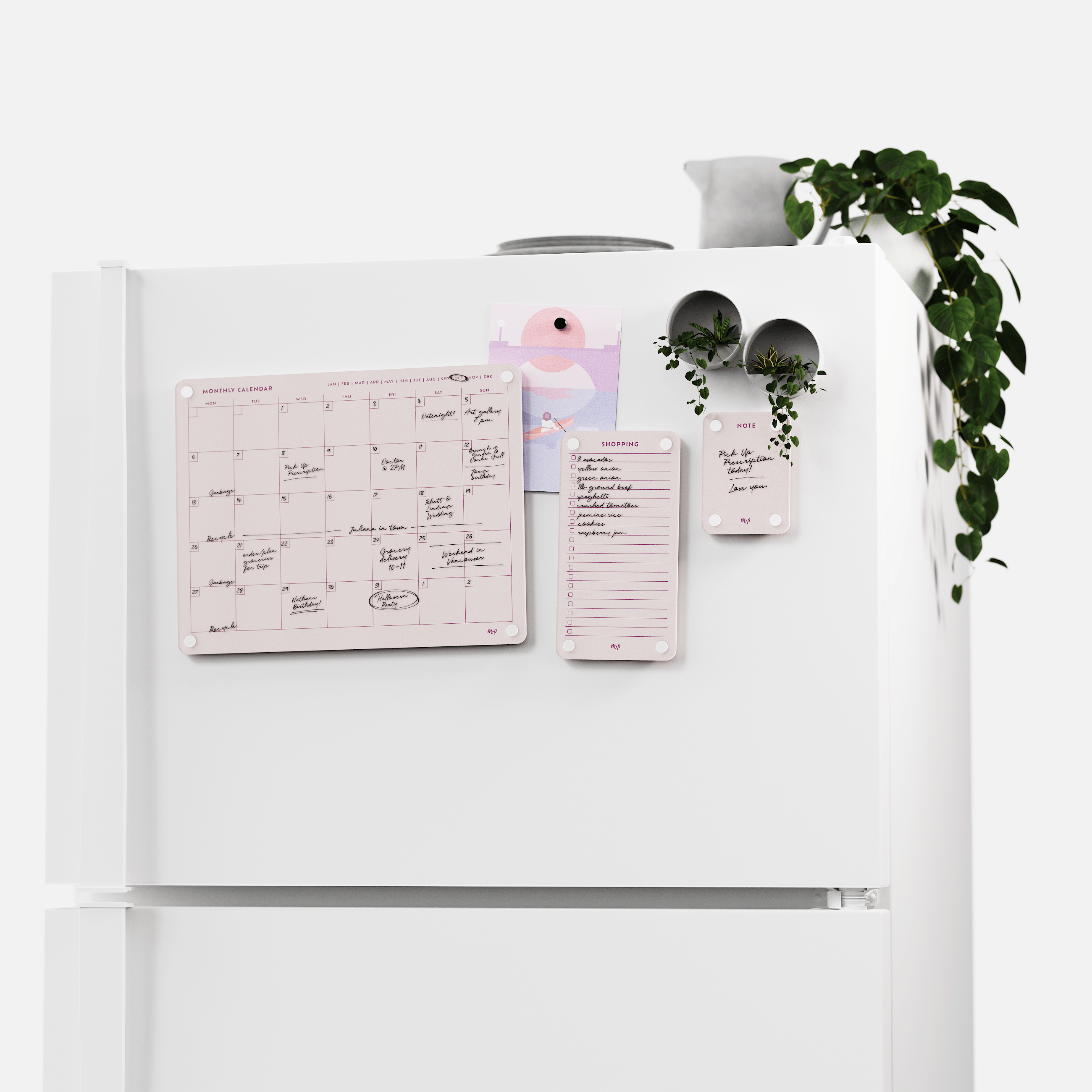 White fridge with the Linen white monthly calendar, shopping list and note board set, plants on top